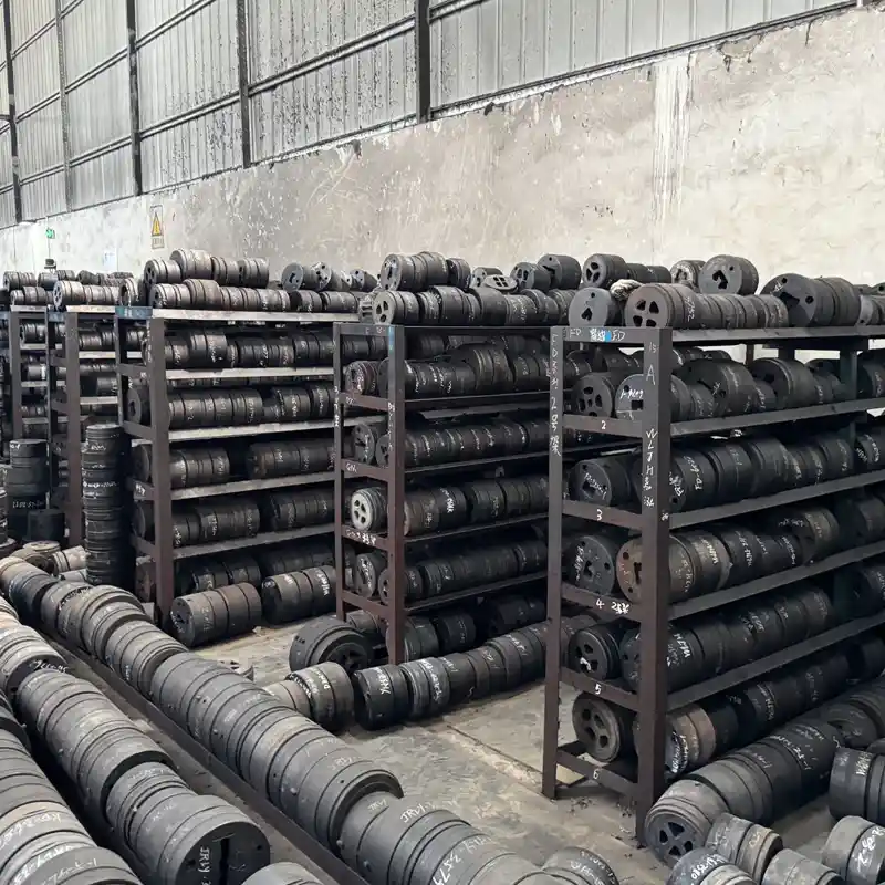 Organized factory storage racks holding hundreds of custom aluminum extrusion dies and molds.