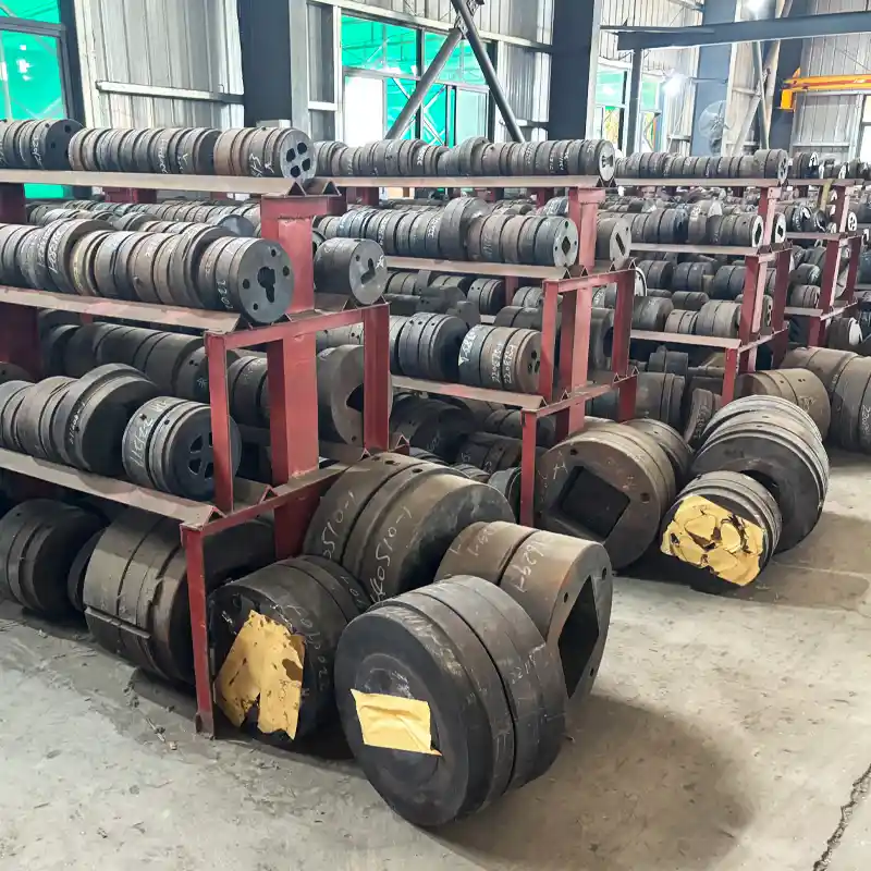 Massive inventory of custom aluminum extrusion dies and tooling stored on heavy-duty factory racks.
