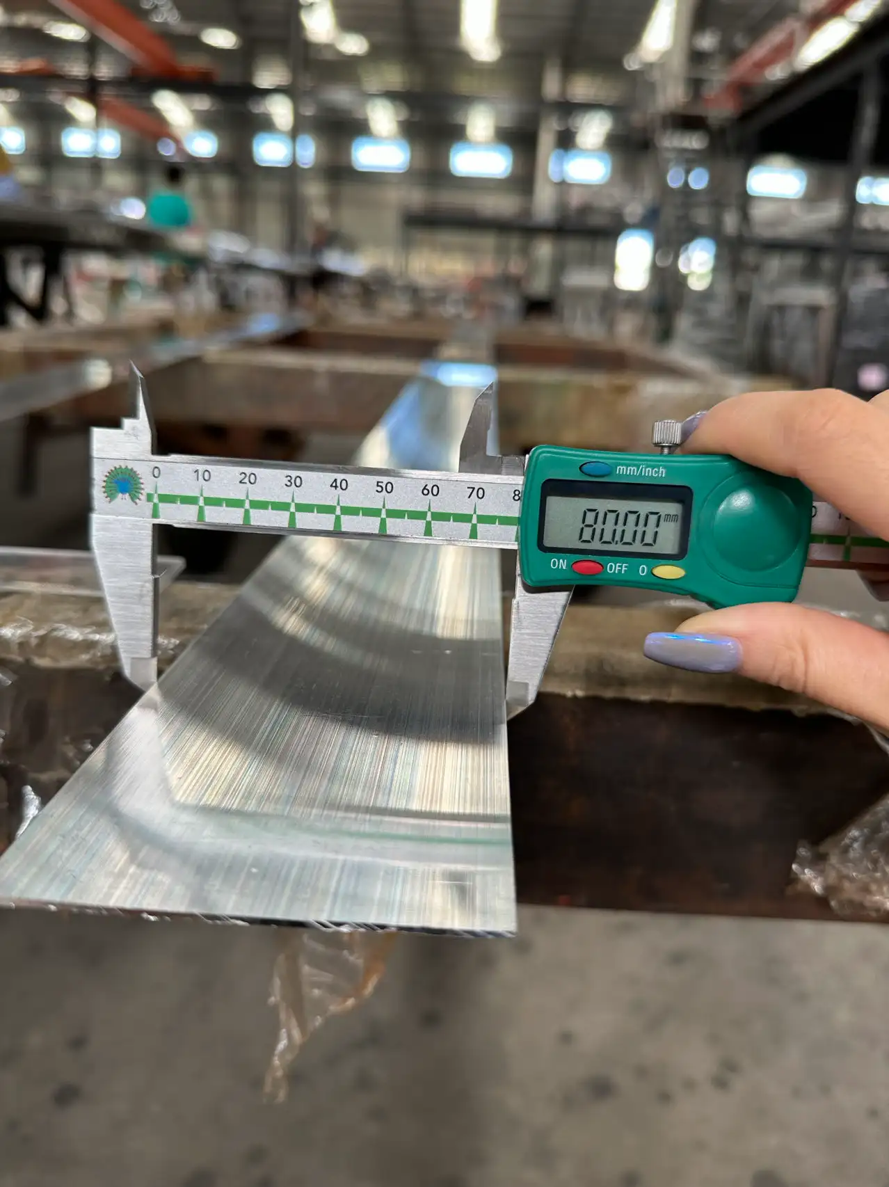 Worker using digital caliper
