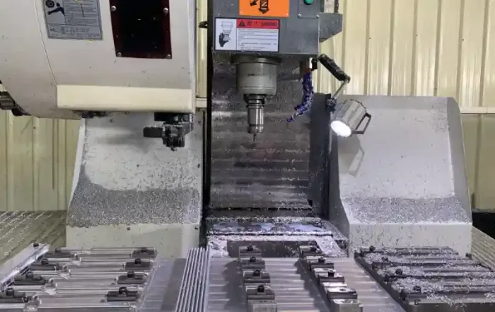 Precision vertical CNC machining center at Shenghai Aluminum factory, deep processing complex industrial aluminum components with massive chip removal.